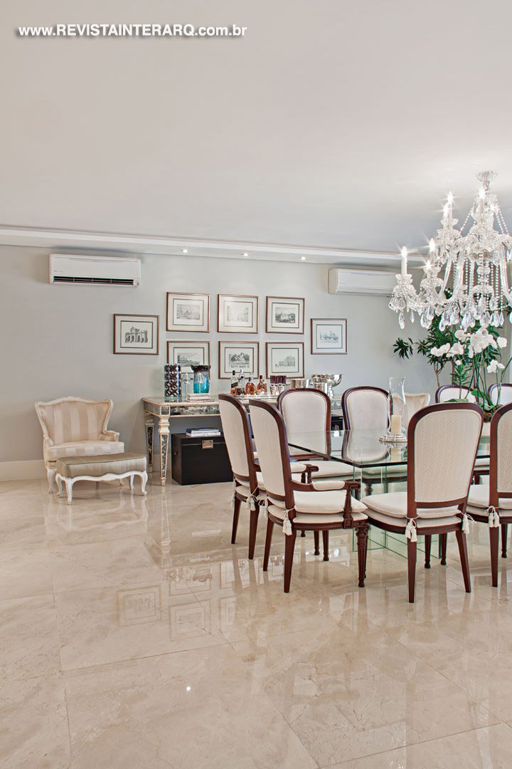 No espaço de jantar, destaque para o imponente lustre de cristal e para a mesa em cristal Jacqueline Terpins e cadeiras da Jackie Móveis. A luminotécnica é da ViaLight e papel de parede da Tenda Decorações