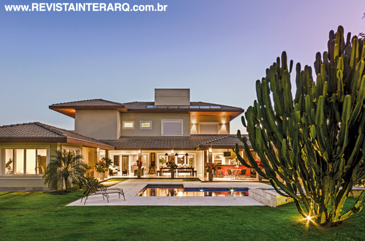 A arquitetura charmosa, com telhado e estrutura de madeira Garapeira aparente (Assis Madeiras) foi completada com textura Terracor nas paredes (Toque Final) e revestimentos naturais, como pedra e cimento. Em contraponto à rusticidade, a tecnologia ganhou destaque para facilitar o dia a dia e está presente no sistema de automação, que comanda a irrigação do belo jardim, sonorização (JR Som) e iluminação. A casa também ganhou um sistema de aspiração central (Techdomus). No entorno da piscina revestida com pastilhas da Atlas, deck com piso atérmico da Castelatto (tudo da Toque Final). Os equipamentos da piscina são da Hidrogás. Os caixilhos em PVC são da Claris (Assis Madeiras)