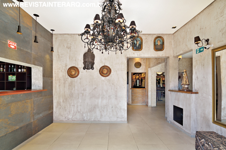 O imenso lustre negro e ferragens ebanizadas marcam a recepção com elementos orientais. A bilheteria foi revestida com porcelanato que lembra o aço envelhecido (Portobello Shop)