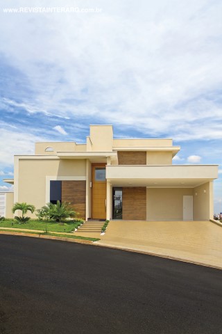 Na fachada em linhas retas e diferentes planos de volumetria, se destaca o painel de porcelanato amadeirado Villagres (Casa dos Construtores