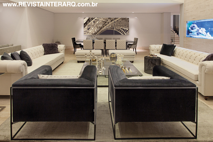 Luzes pontuais (Dessine) ressaltam a beleza de móveis como as cadeiras e a mesa da sala de jantar (Artefacto), ao fundo
